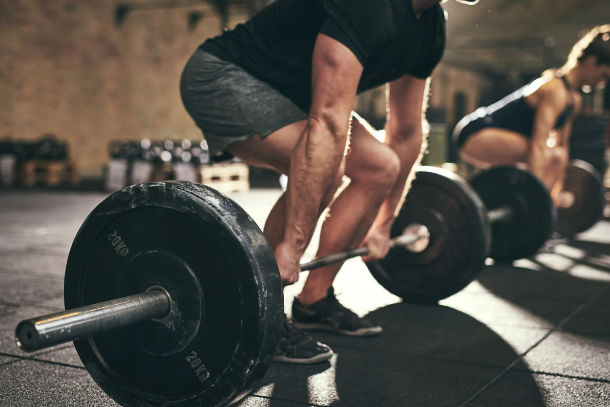 Deadlift on ground with man about to lift it