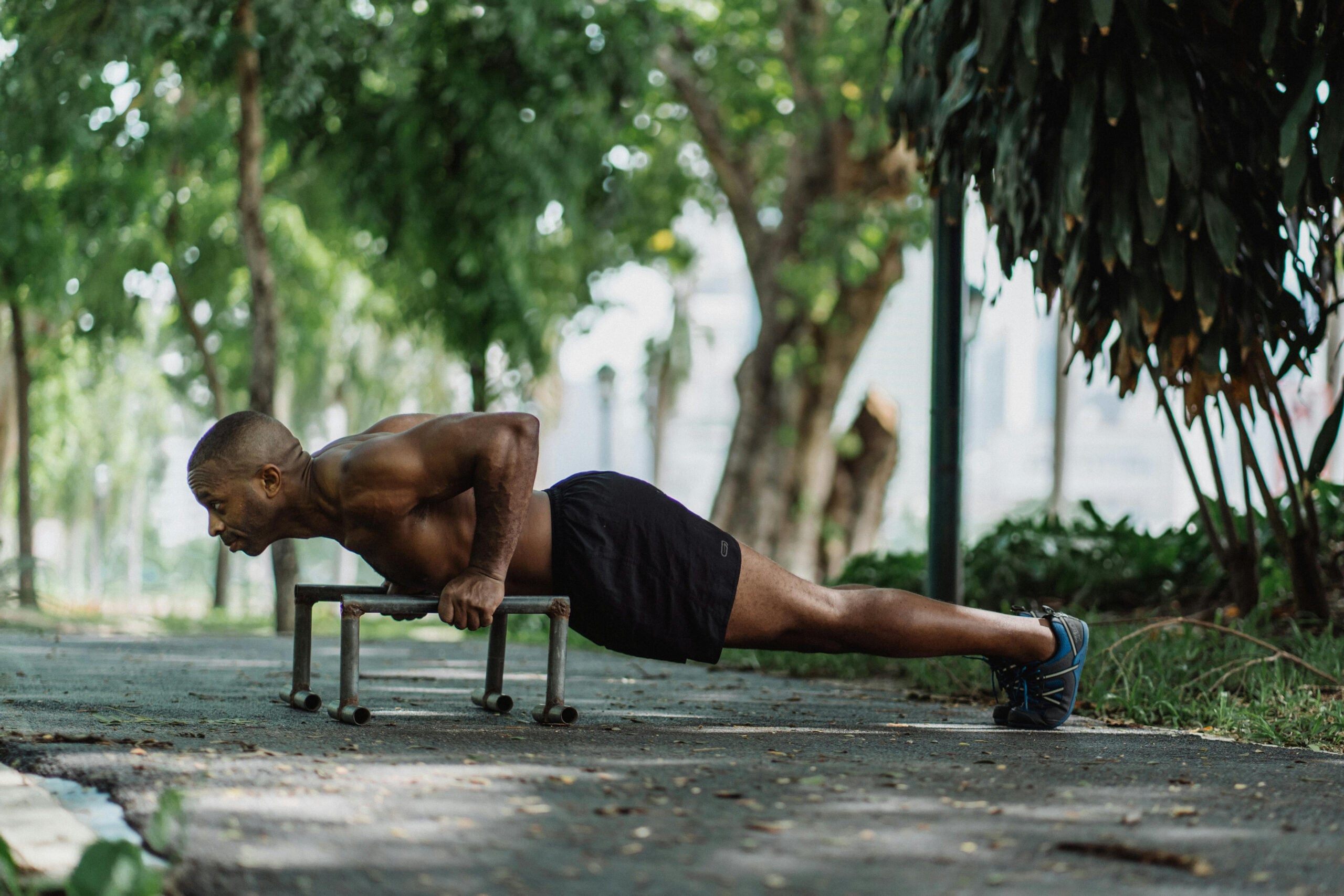 Man in Black Shorts Doing Push-ups