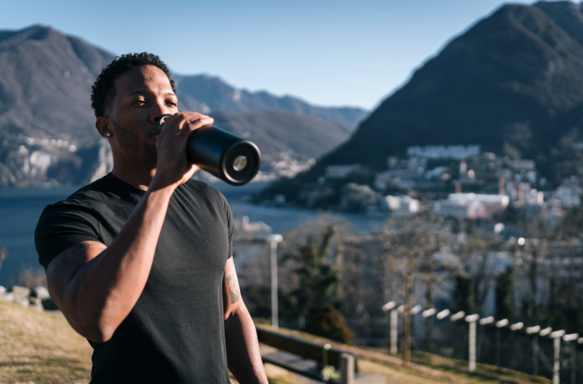 athlete hydrating while training in the mountains