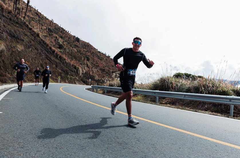 athlete jogging down mountain road